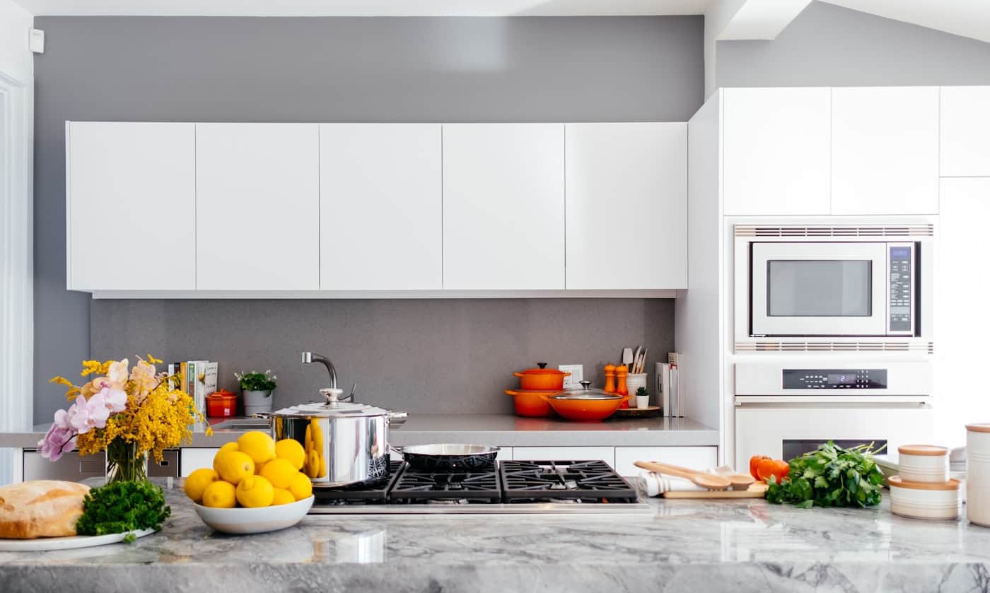 Bright white kitchen with citrus on the counter and afternoon light