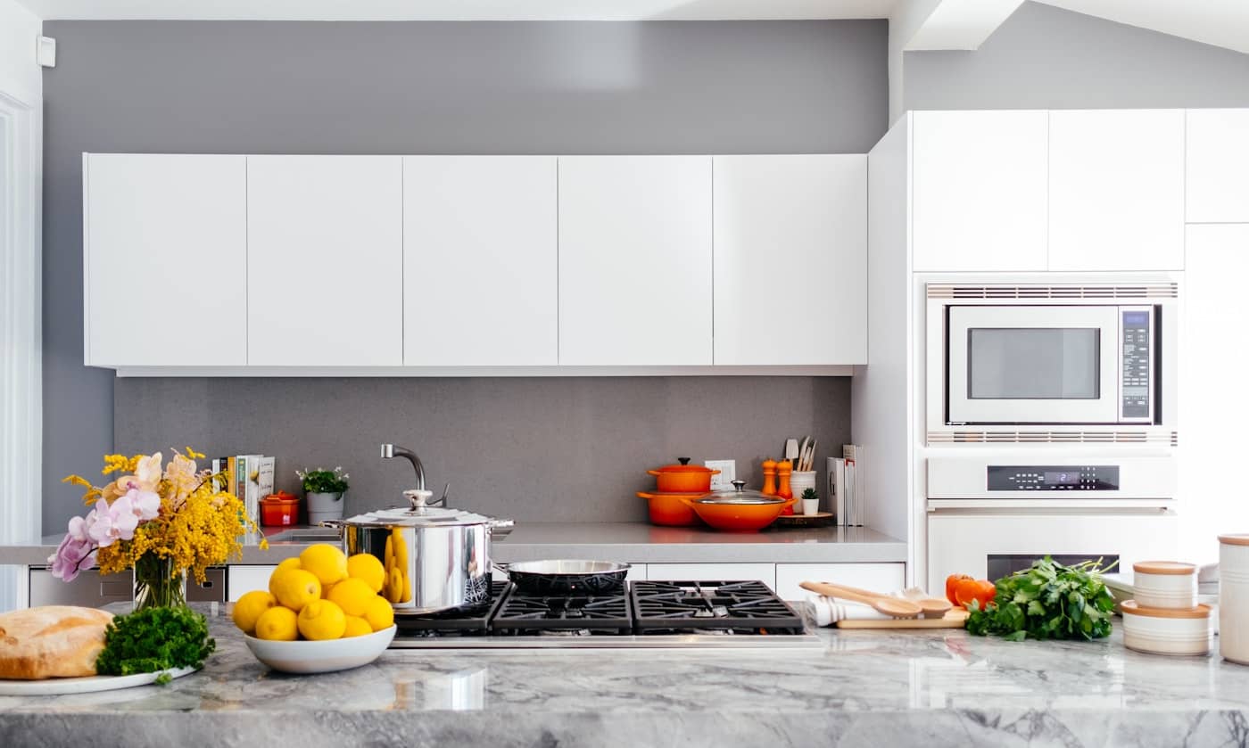 Bright white kitchen with citrus on the counter and afternoon light