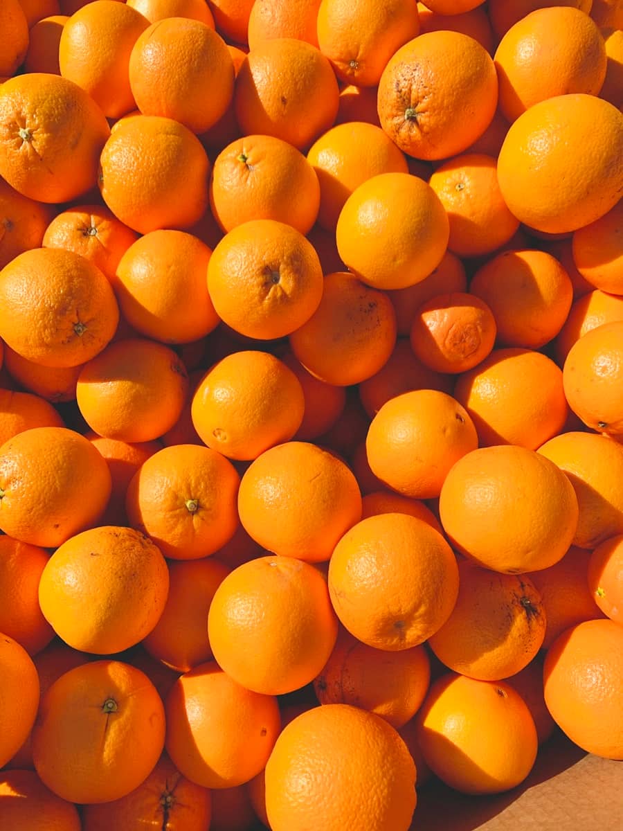 A crate of bright Florida oranges in the sun