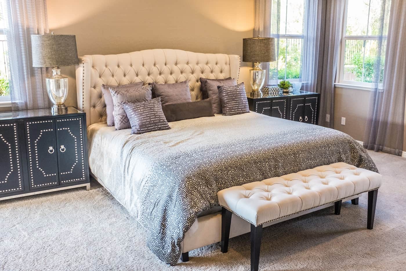 Bright, calm master bedroom with a neatly made bed